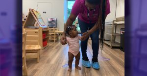 Caregiver Assisting Infant
