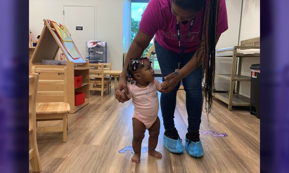Caregiver Assisting Infant