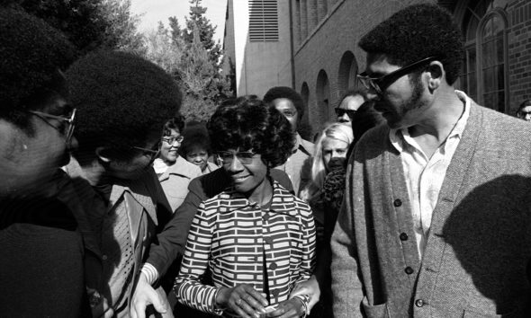 ON 'CHISHOLM TRAIL'—Shirley Chisholm leaves USC's Bovard Auditorium, where she said Presidency should not be exclusive domain of white males." 24 January 1972. Photo: Tony Barnard, Los Angeles Times.