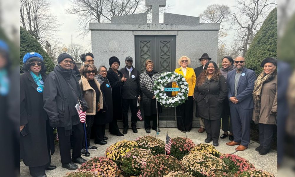 Members of the Mayor Harold Washington Legacy Committee present a wreath at the former mayor’s gravesite at Oak Woods Cemetery (Photo Credit: Tacuma R. Roeback).