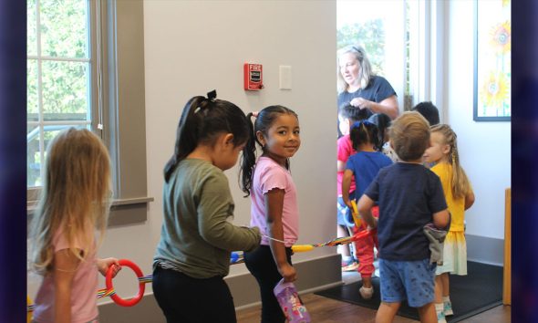 Students in Ocracoke School’s universal pre-k classroom for 3- and 4-year-olds walk in a line together toward the playground. Photo by: Katie Dukes, EdNC