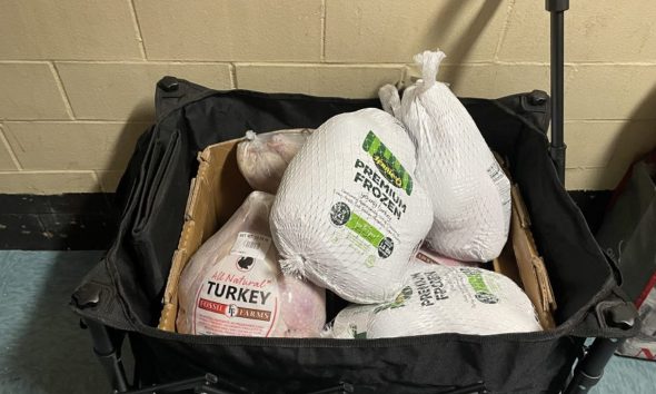 This year’s giveaway provided 87 turkeys and Boxes of Love floor-by-floor of the 14th floor housing complex. Credit: Sherica Daley photo