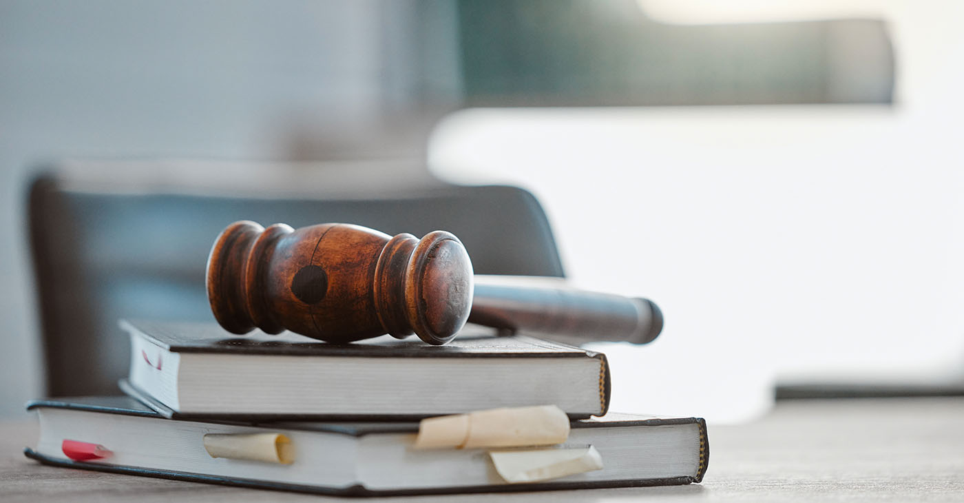 Justice, gavel and law books on table in office for court trial (Photo By Jacob Wackerhausen)