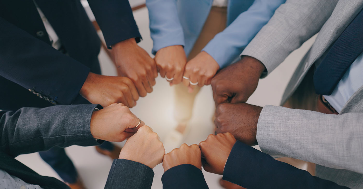 Businesspeople, teamwork and fist of hands in circle for collaboration, synergy and motivation of global equality from above (Photo By Jacob Wackerhausen)