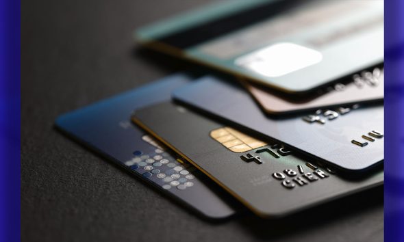 stack of multicolored credit cards on black background