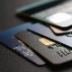 stack of multicolored credit cards on black background