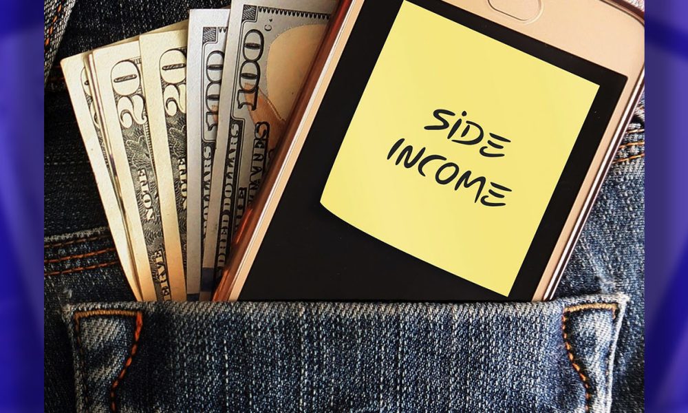 Cash dollars money and mobile phone in jean pocket with note written SIDE INCOME, concept of earning extra cash from side job , side hustle or make more income from online business