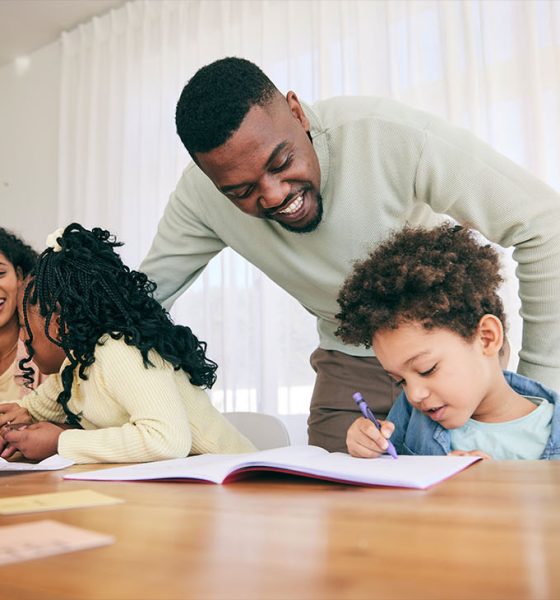 Writing, drawing and parents with children for homework, school activity and learning with notebooks (Photo Credit by Jacob Wackerhausen)