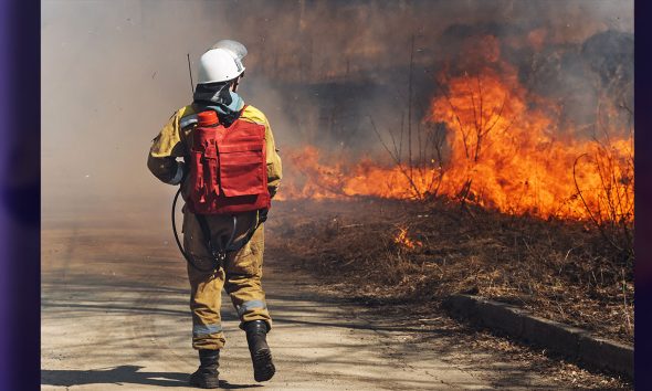 Professional Firefighter Extinguishing Large, the Forest Fire. (Photo By Sergey Dolgikh)