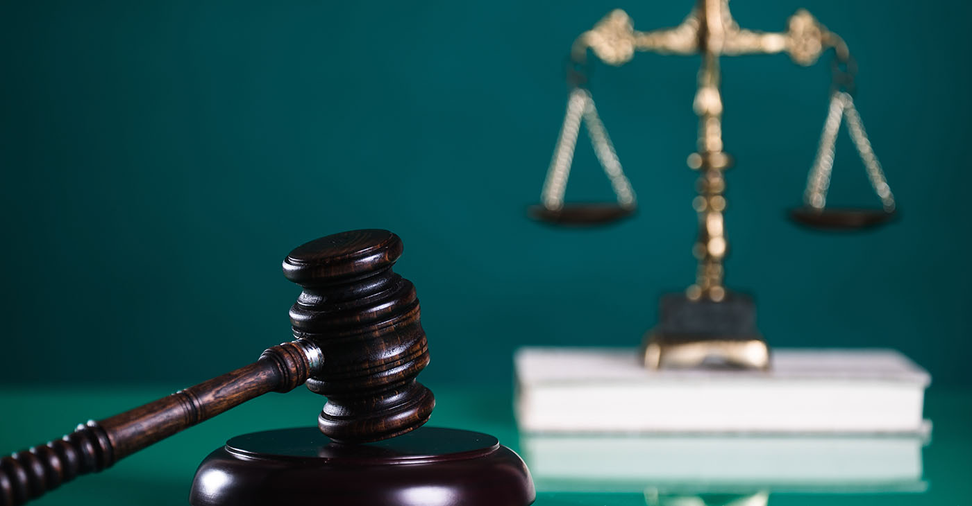 Law and Justice concept. Mallet of the judge, books, scales of justice (Photo by Michał Chodyra)