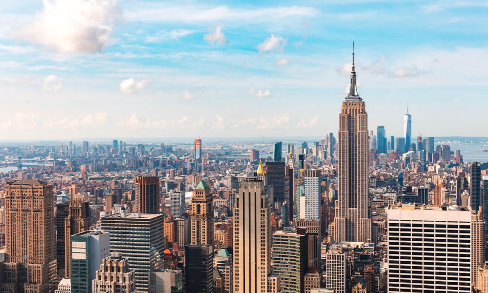 Iconic buildings overlooking bustling new york city with impressive architecture and vibrant energy in warm sunlight