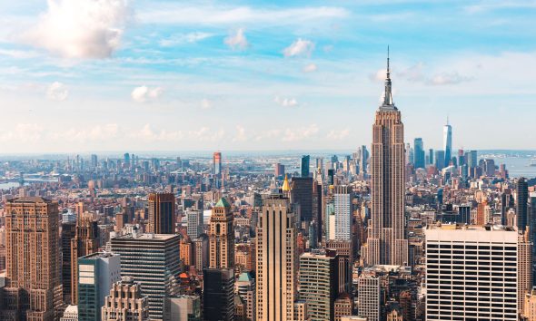 Iconic buildings overlooking bustling new york city with impressive architecture and vibrant energy in warm sunlight