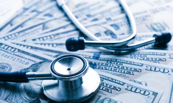 The cost of healthcare. Blue toned (Photo by Valeriya)