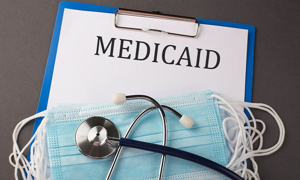 Folder with paper text MEDICAID , on a table with a stethoscope and medical masks, medical (Photo by Iryna Drozd)