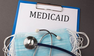 Folder with paper text MEDICAID , on a table with a stethoscope and medical masks, medical (Photo by Iryna Drozd)