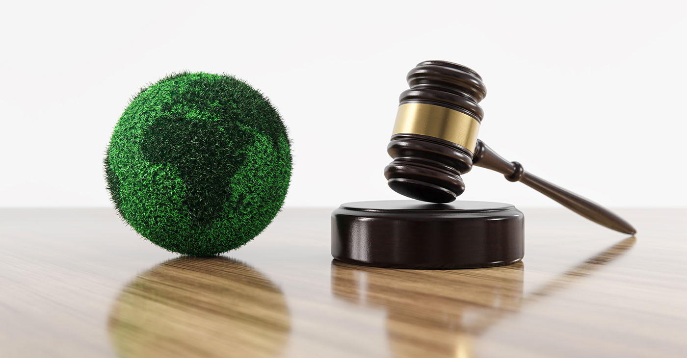 Environment Law. Green Globe World and gavel hammer. Environmental protection and eco-friendly legislation law. Save Earth. ESG concept. (Photo by Alexander Sikov)