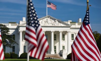 This compelling photograph captures the essence of American democracy with a captivating view of the White House in the background, framed by a row of American flags in the foreground. The flags, symbolizing the nation's unity and resilience, stand proudly in front of one of the most iconic landmarks in the United States. (Photo by Castle City Creative)