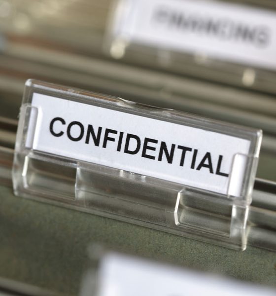 Inside of a filing cabinet with green folders and focus on confidential label (Photo by Brian A Jackson)