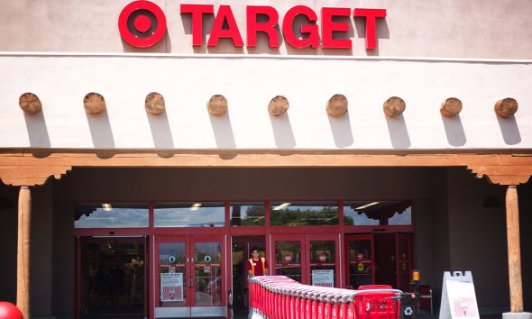 Santa Fe, NM: A Target employee pulls red shopping carts into the Santa Fe NM store. Santa Fe’s Target is constructed in the Southwest Pueblo architectural style. (Photo by Jann Huizenga)