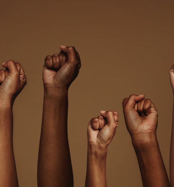Cropped shot of hands raised with closed fists. Multiple hands raised up with closed fist symbolizing the protests movement. (Photo by Jacob Lund