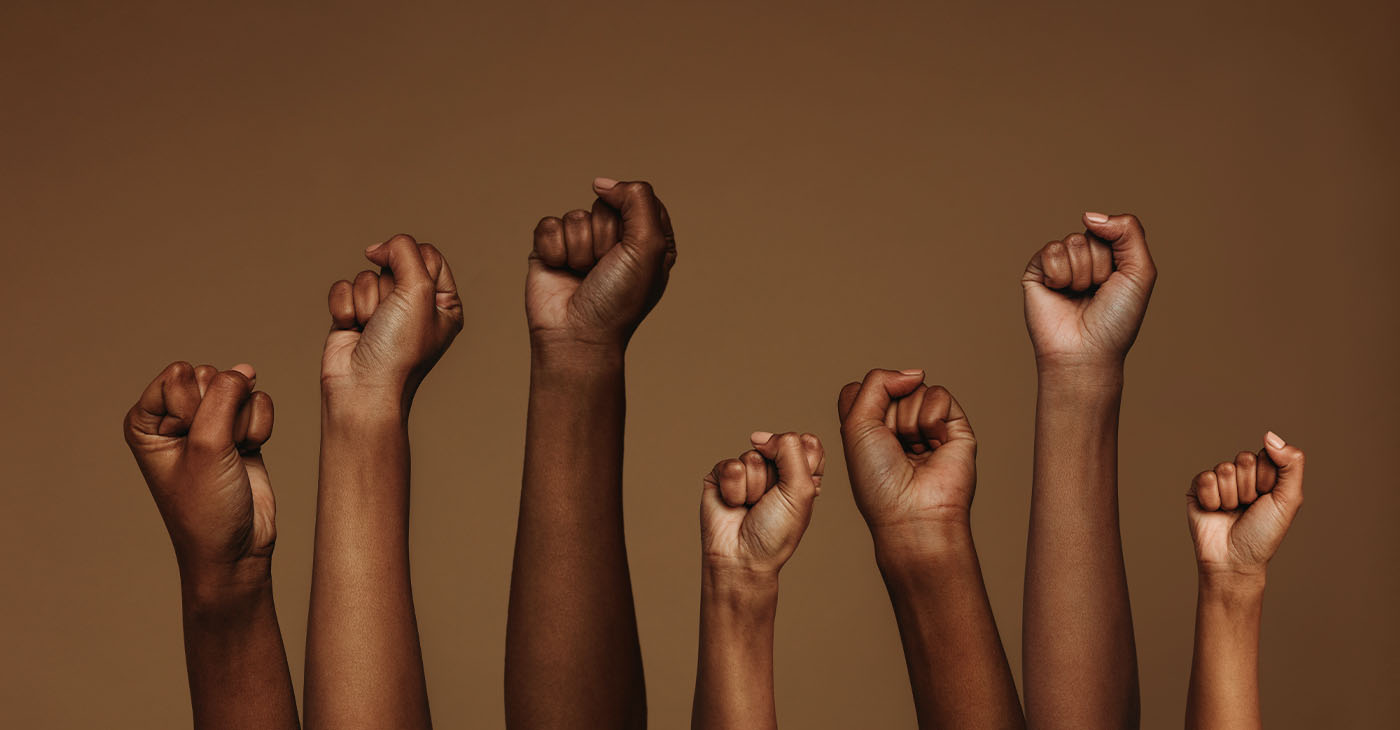 Cropped shot of hands raised with closed fists. Multiple hands raised up with closed fist symbolizing the protests movement. (Photo by Jacob Lund