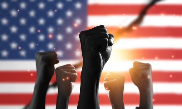 American flag with black people raise their hands to protest in the United States for racism and racial inequality.