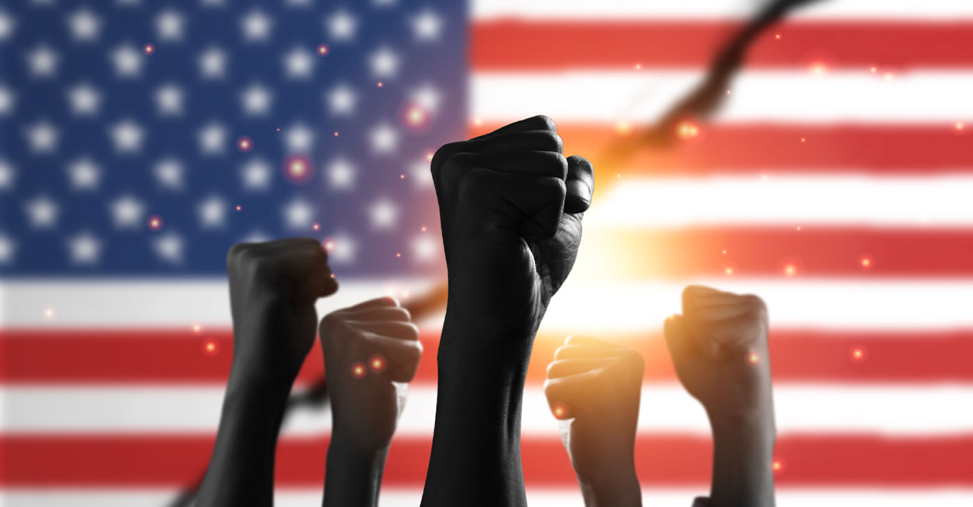 American flag with black people raise their hands to protest in the United States for racism and racial inequality.