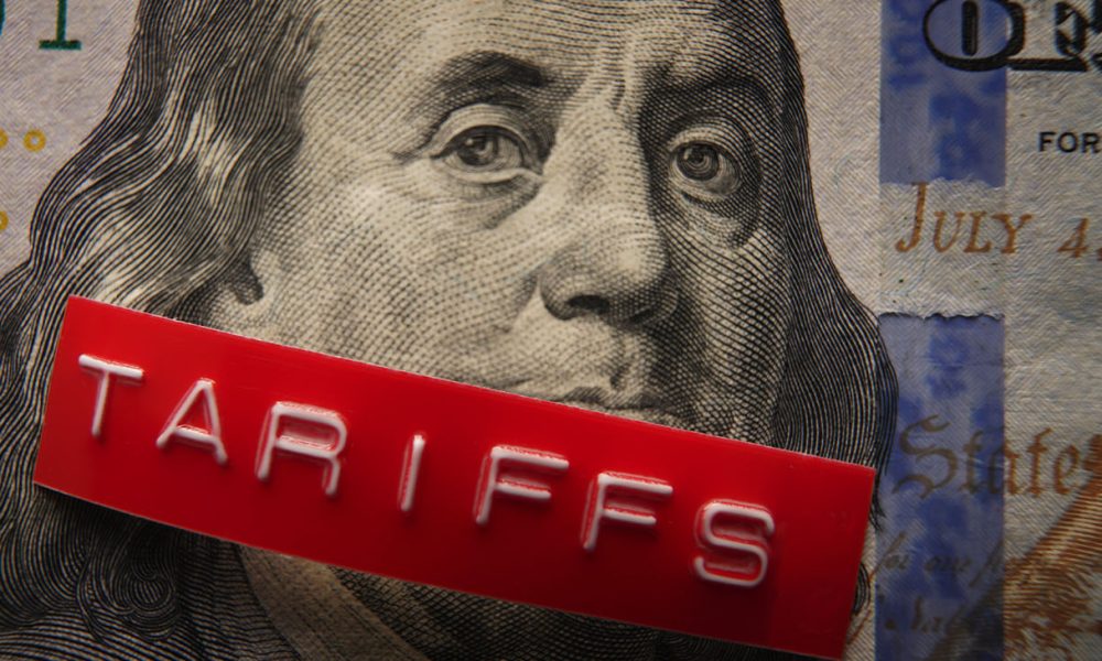 Red Tariffs label on a hundred dollar bill