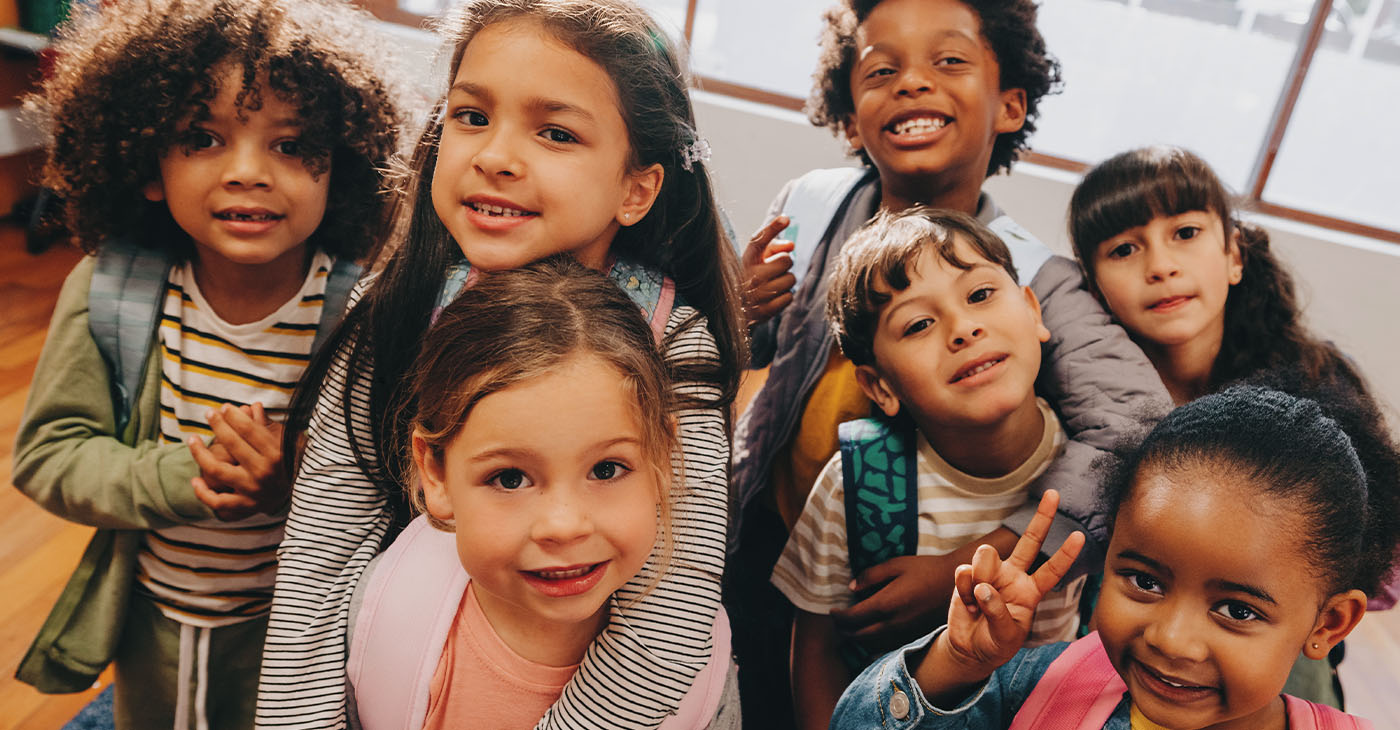 Class selfie in an elementary school. Kids taking a picture together in a co-ed school. Group of elementary school children feeling excited to be back at school. (Photo by Jacob Lund)