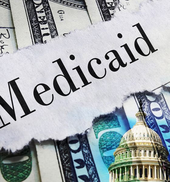 Medicaid newspaper headline on hundred dollar bills with US Capitol in Washington DC