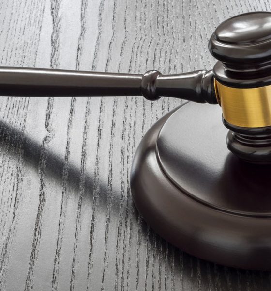 Wood gavel and open handcuffs symbolizing freeing judge decisions