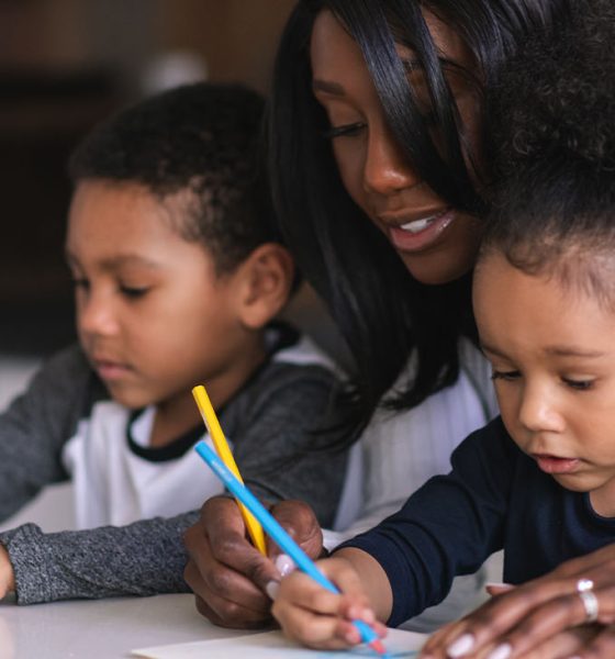Two mixed race children of elementary school age attend class from home. School has been cancelled due to the COVID-19 Pandemic.