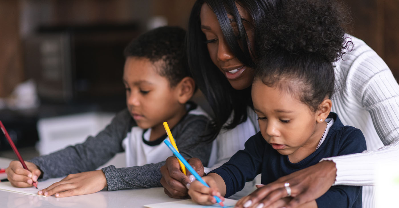 Two mixed race children of elementary school age attend class from home. School has been cancelled due to the COVID-19 Pandemic.