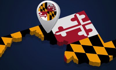 Flag of State of Maryland of USA on map on dark background. Vector illustration (Photo by Zloyel)