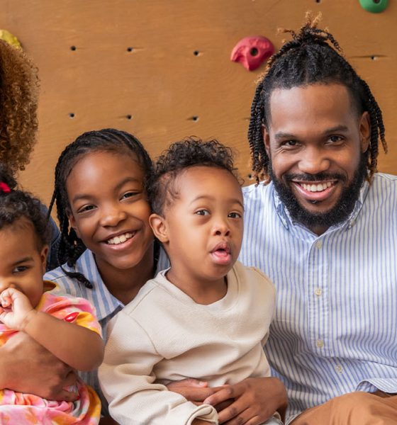 Little boy with Down Syndrome with his parents and sisters ( Photo by Courtney Hale)