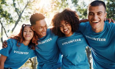 Volunteer, friends and portrait of people in park for recycle program, earth day or social responsibility. Environment, climate change and NGO with group in nature for non profit, cleaning or charity (Photo by Jacob Wackerhausen)