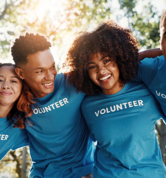 Volunteer, friends and portrait of people in park for recycle program, earth day or social responsibility. Environment, climate change and NGO with group in nature for non profit, cleaning or charity (Photo by Jacob Wackerhausen)