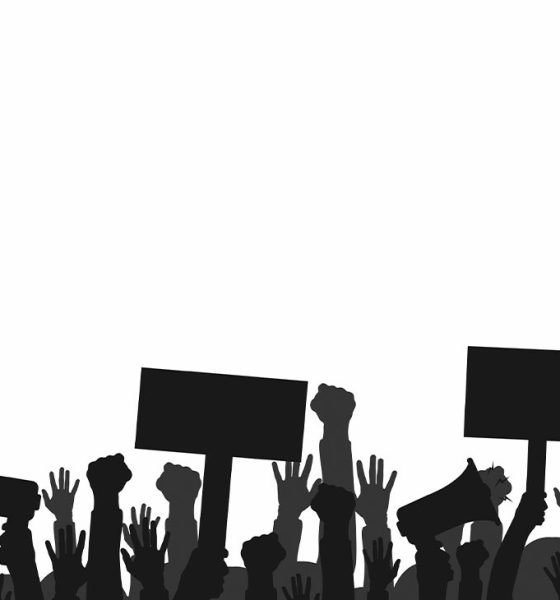 Crowd of protesters people. Silhouettes of people with banners and megaphones. Concept of revolution or protest. Vector (Photo by Yevhenii Dubinko)
