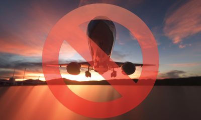 Stop Sign with Passenger's Airplane on a sunset sky background. 3d rendering.
