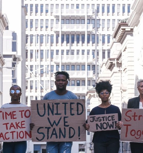 Protest group activism, justice portrait and change in street with poster in hands. Crowd people writing, city sign for solidarity peace or diversity of race, religion and community in metro together (Photo by Armand Burger)