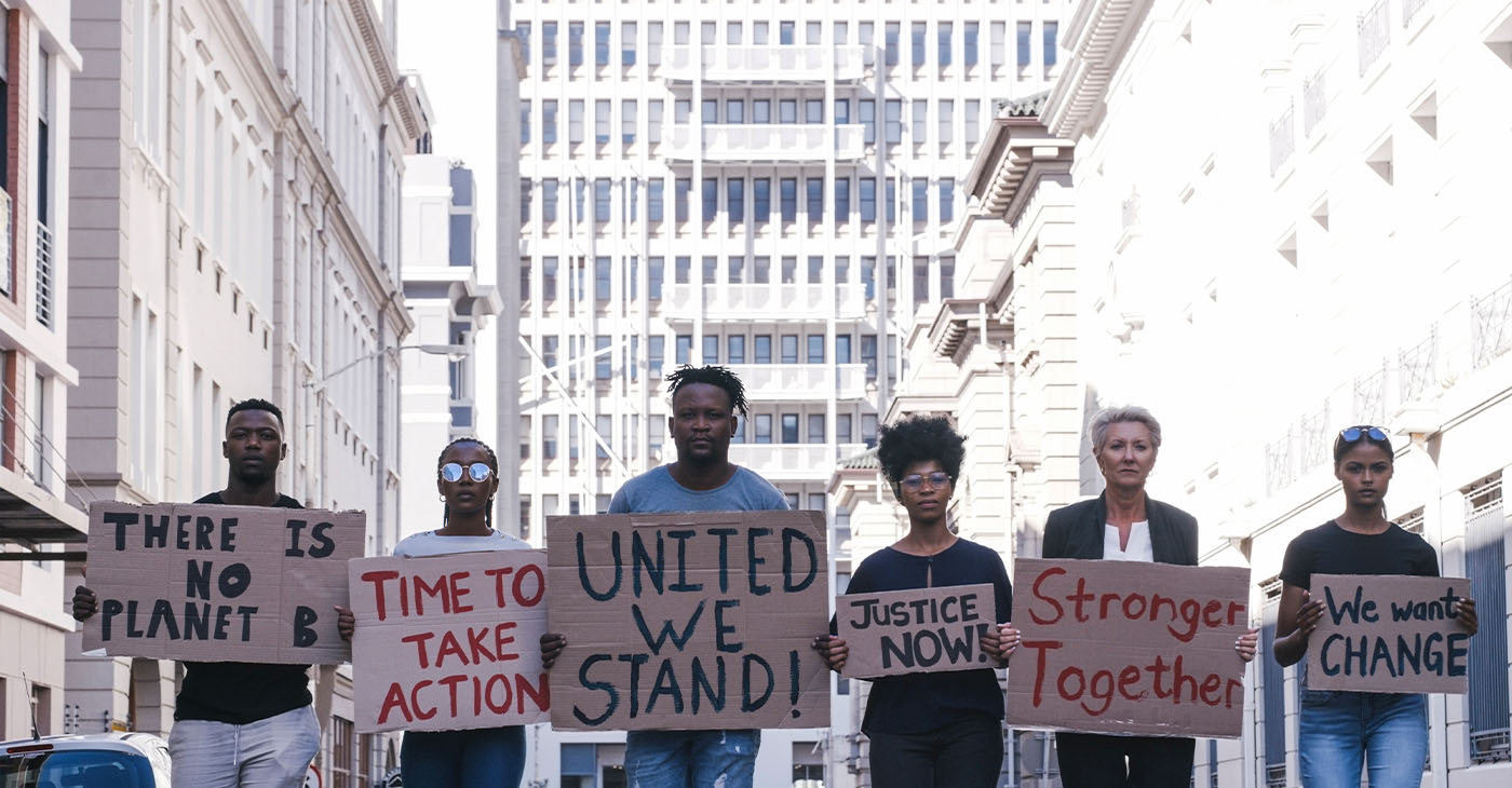 Protest group activism, justice portrait and change in street with poster in hands. Crowd people writing, city sign for solidarity peace or diversity of race, religion and community in metro together (Photo by Armand Burger)