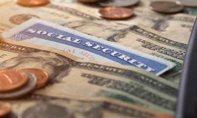 Social security and medicare concept with social security card and pile of money.