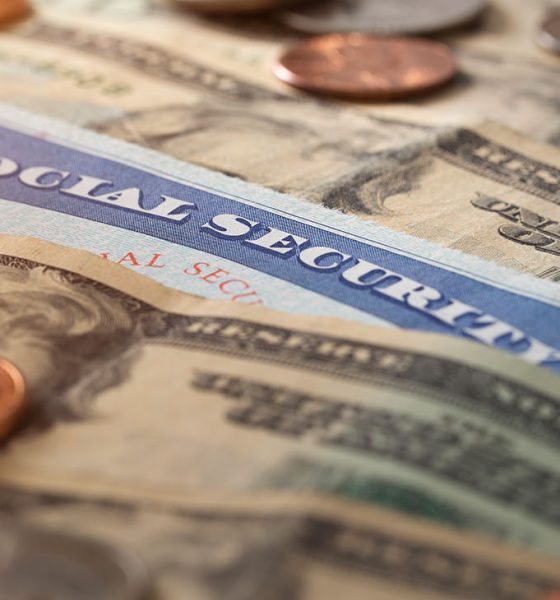 Social security and medicare concept with social security card and pile of money.