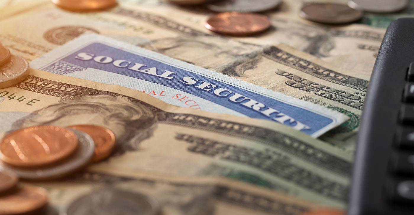 Social security and medicare concept with social security card and pile of money.