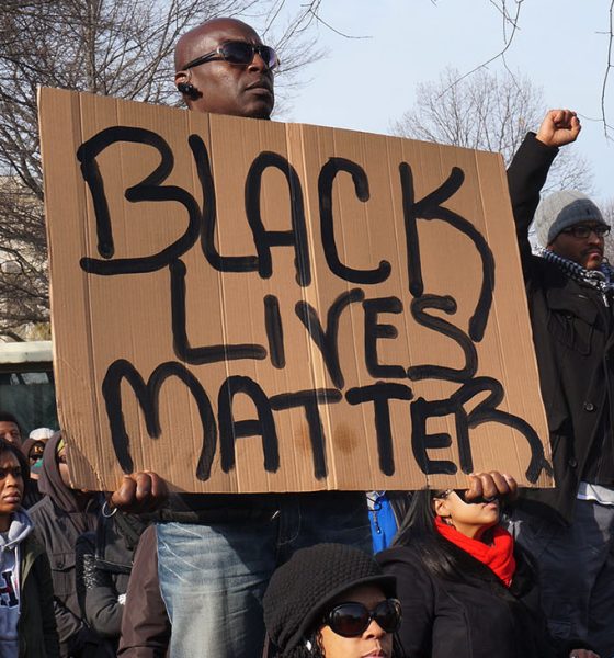 Washington DC, USA-December 13, 2014: This man is protesting police brutality at a protest led by Reverend Al Sharpton on Pennsylvania Avenue in Washington DC. He displays a sign with the message Black Lives Matter. Recently the deaths of Michael Brown, Eric Garner and Tamir Rice have upset the black community.