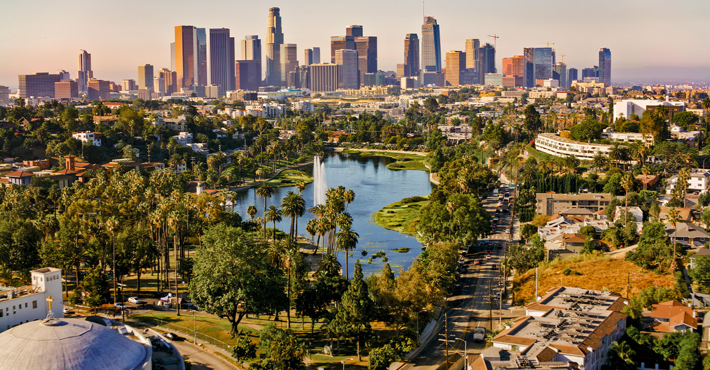 Aerial view of Echo Park Lake surrounded by neighbourhood with high rise office buildings in background, City Of Los Angeles, California, USA.