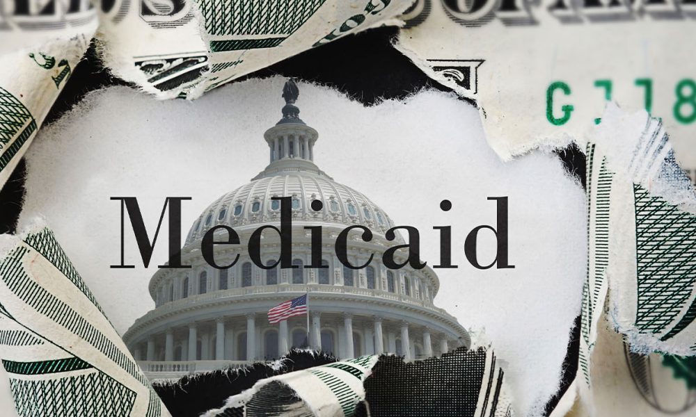 Torn dollar bill with medicaid text and US Capitol