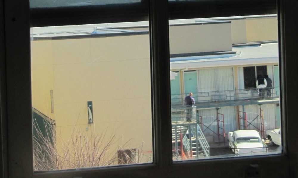 View of Lorraine Hotel, from second floor bathroom window in the boarding house from where James Earl Ray was alleged to have fired the fatal shot at Martin Luther King, Jr. Boarding house view of Lorraine Motel balcony. Photo: Mr. Littlehand / Wikimedia Commons.