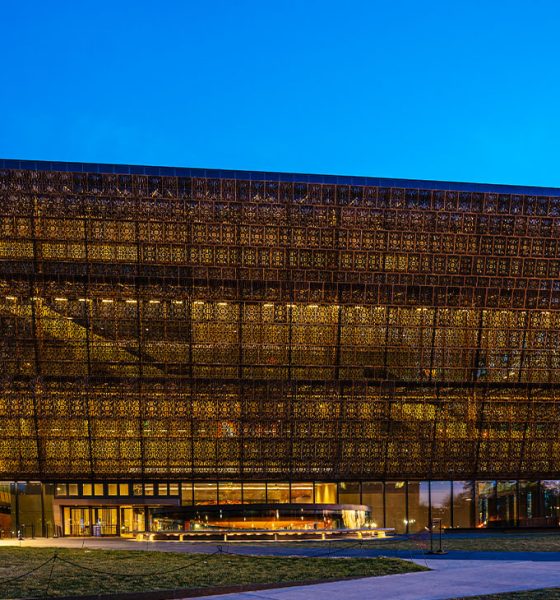 Washington D.C., USA - February 10, 2023: The National Museum of African American History and Culture at night with the Washington Monument in downtown Washington DC.