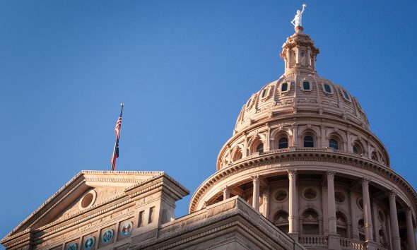 Texas state capitol building dome with a blue sky in the background
